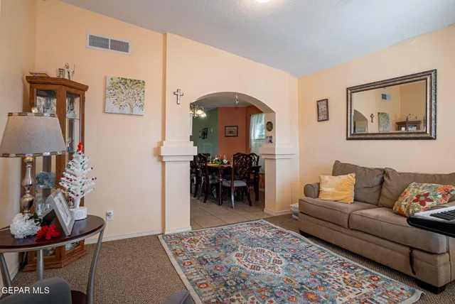 a living room with furniture and dining area