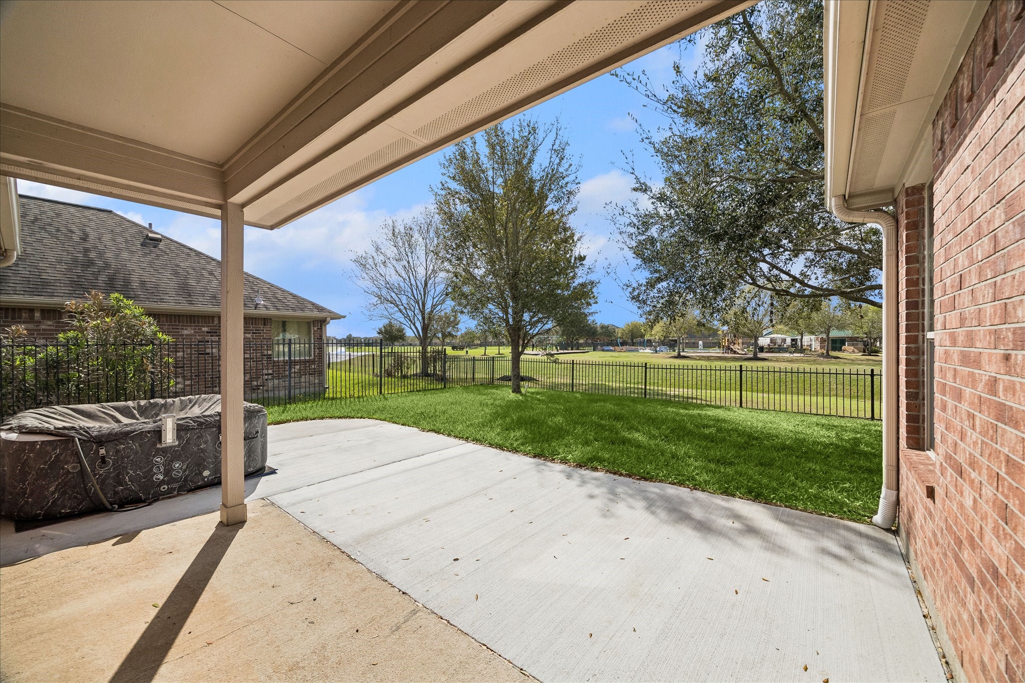7806 Summer Night Lane Rosenberg, TX 77469 - Photo 20 of 23 View from the covered patio overlooks the spacious backyard and surrounding greenery, creating a refreshing outdoor setting.
