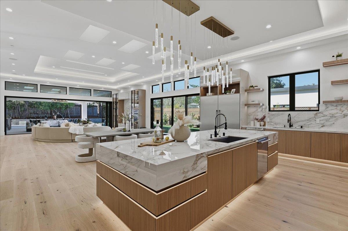 19315 San Marcos Road Saratoga, CA 95070 - Photo 16 of 52 a view of kitchen island a sink and living room view