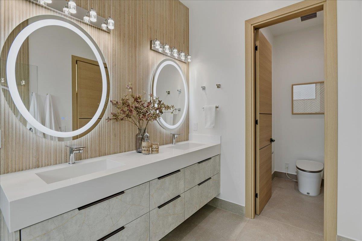 19315 San Marcos Road Saratoga, CA 95070 - Photo 29 of 52 a bathroom with a double vanity sink mirror and toilet