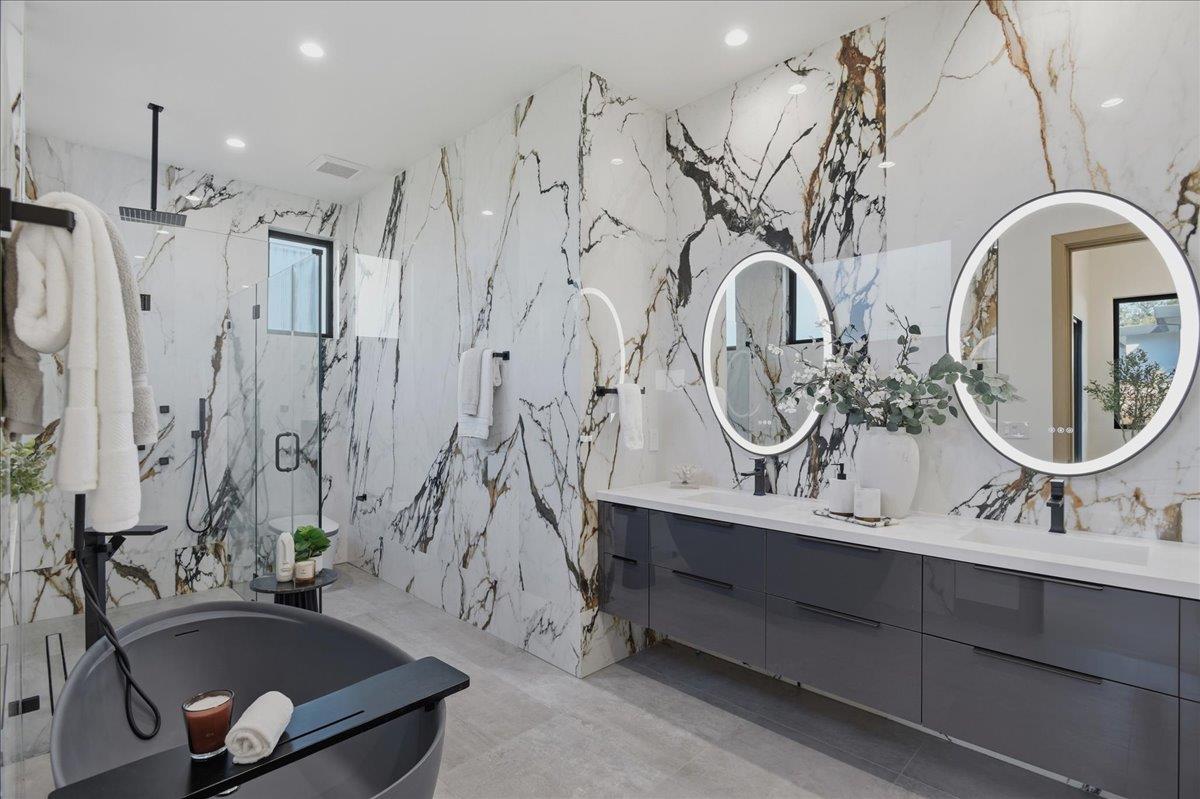 19315 San Marcos Road Saratoga, CA 95070 - Photo 33 of 52 a bathroom with double vanity sinks a mirror and a shower