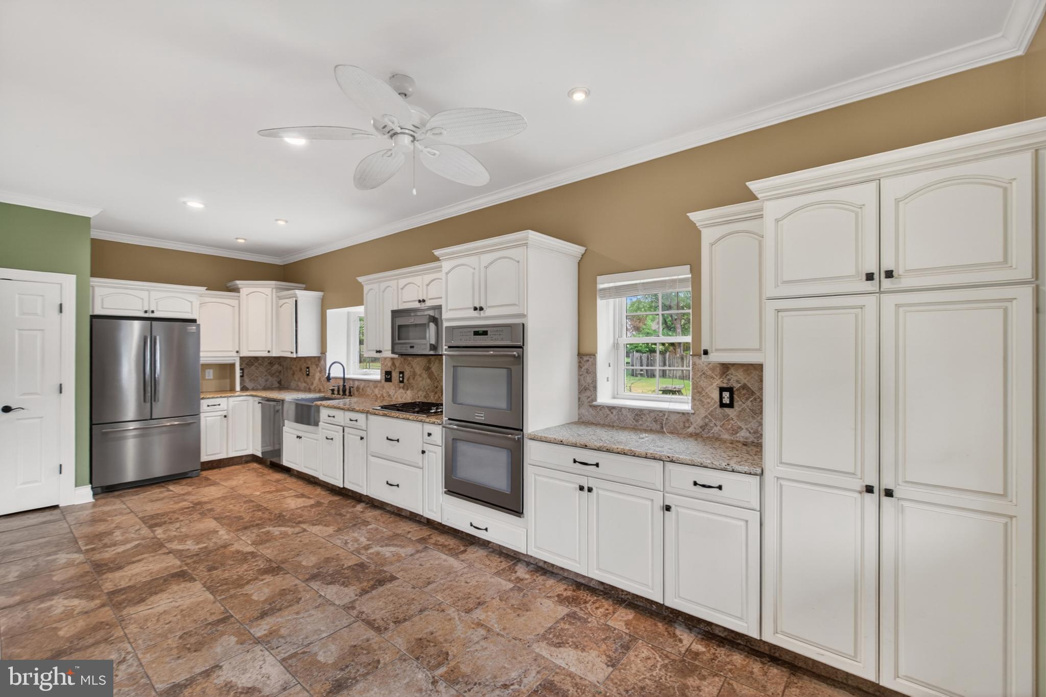 117 State Avenue Lindenwold, NJ 08021 - Photo 22 of 58 a kitchen with white cabinets and stainless steel appliances