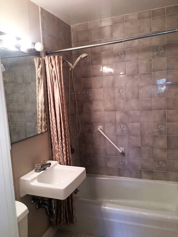 12 Inman Street, Unit 52 Cambridge, MA 02139 - Photo 5 of 12 a bathroom with a sink and a mirror