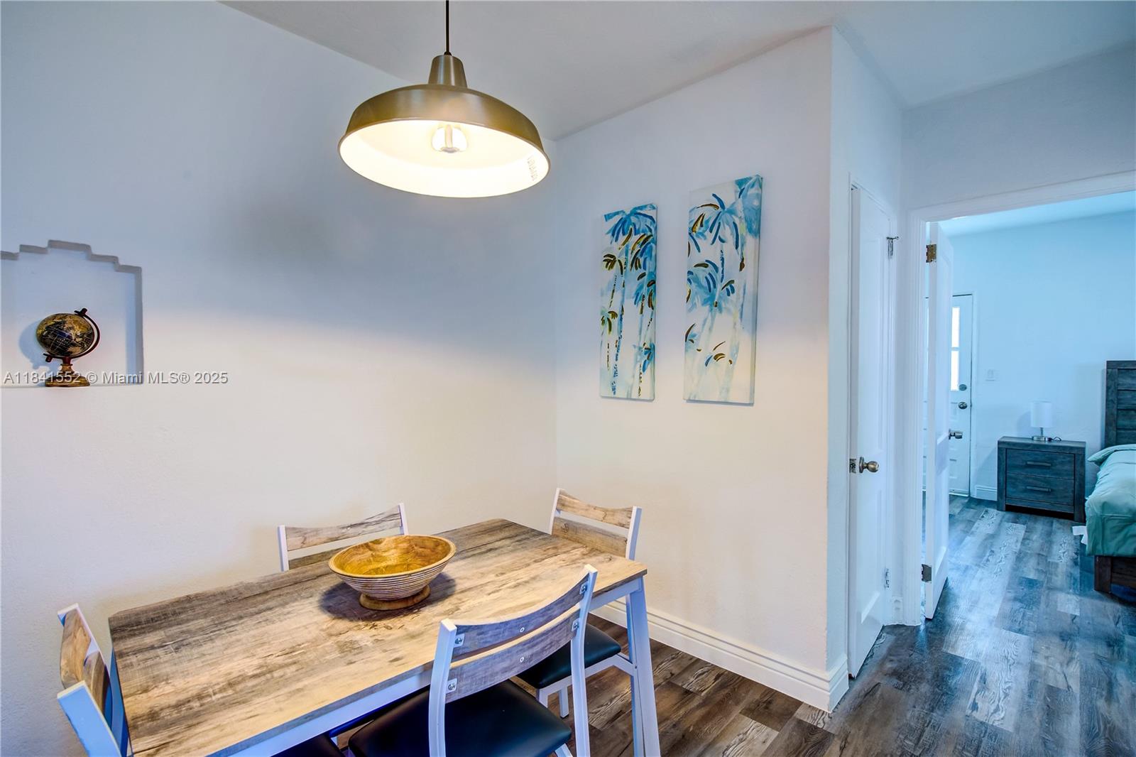 855 Southwest 7th Street, Unit 3 Miami, FL 33130 - Photo 11 of 18 a view of a dining room with furniture and wooden floor