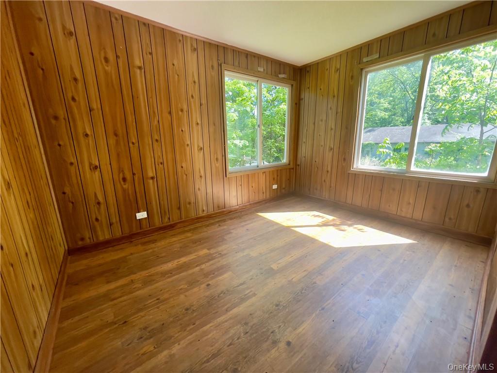 4 Old Turnpike Road Bloomingburg, NY 12721 - Photo 24 of 27 Empty room featuring wood walls and hardwood / wood-style flooring
