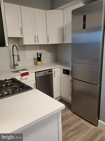 a kitchen with a refrigerator stove and sink