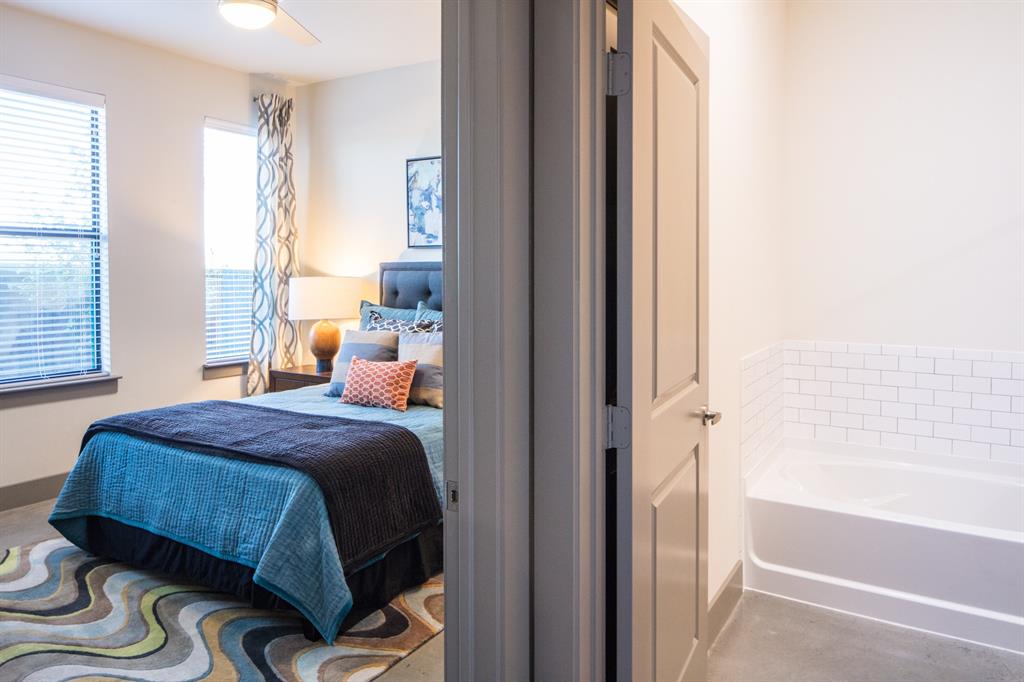 2175 Tucker Street, Unit 2102 Dallas, TX 75214 - Photo 2 of 7 a bedroom with a bed and a window