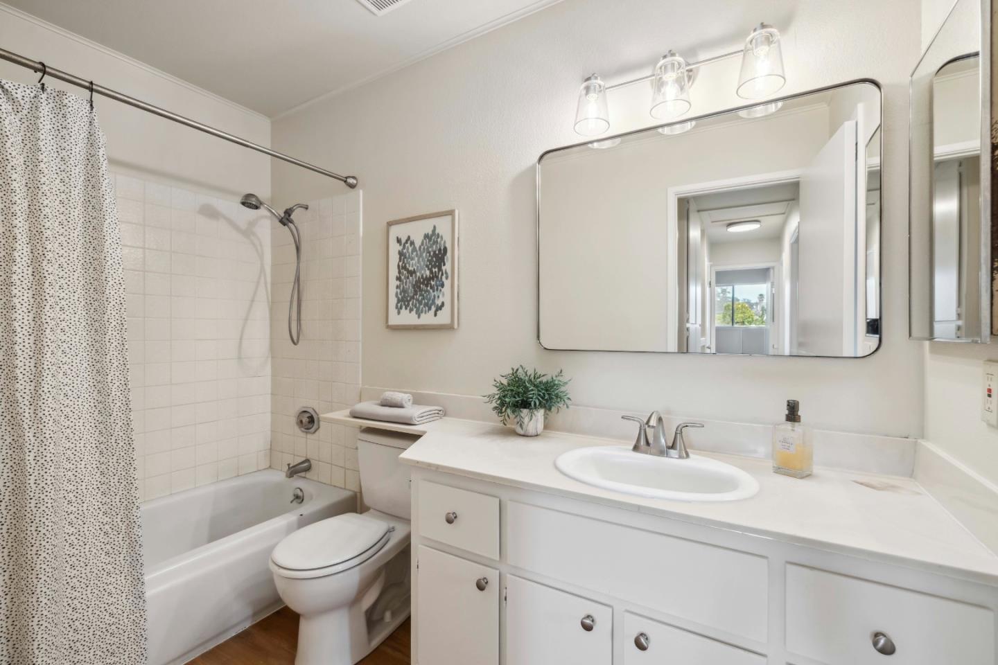 4237 Starboard Court Soquel, CA 95073 - Photo 7 of 26 a bathroom with a sink toilet a mirror a vanity and shower