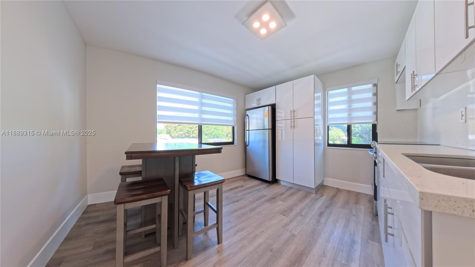 851 East 17th Street, Unit B Hialeah, FL 33010 - Photo 11 of 13 a view of a dining room with furniture and wooden floor