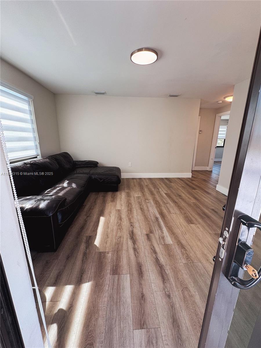 851 East 17th Street, Unit B Hialeah, FL 33010 - Photo 4 of 13 a view of a livingroom with furniture and wooden floor