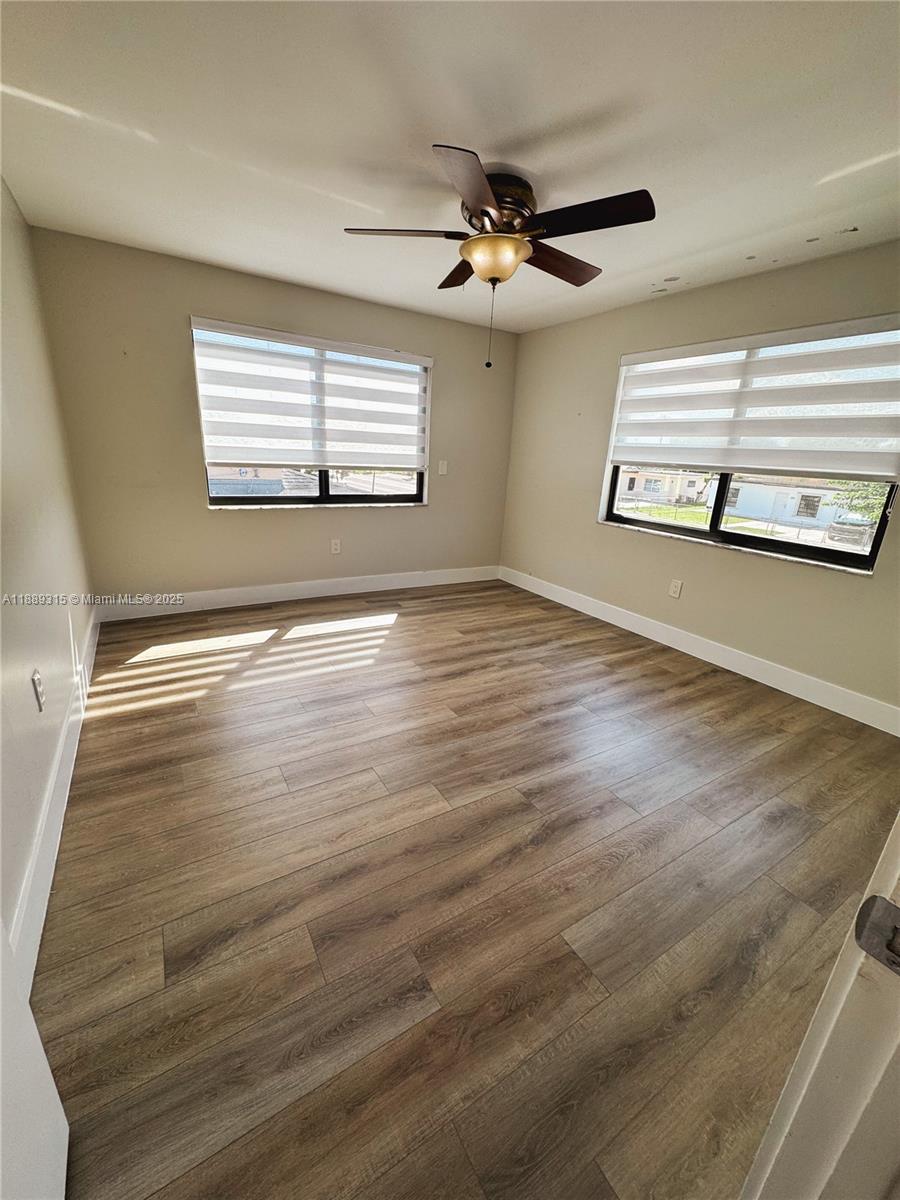 851 East 17th Street, Unit B Hialeah, FL 33010 - Photo 6 of 13 a view of an empty room with wooden floor and a window