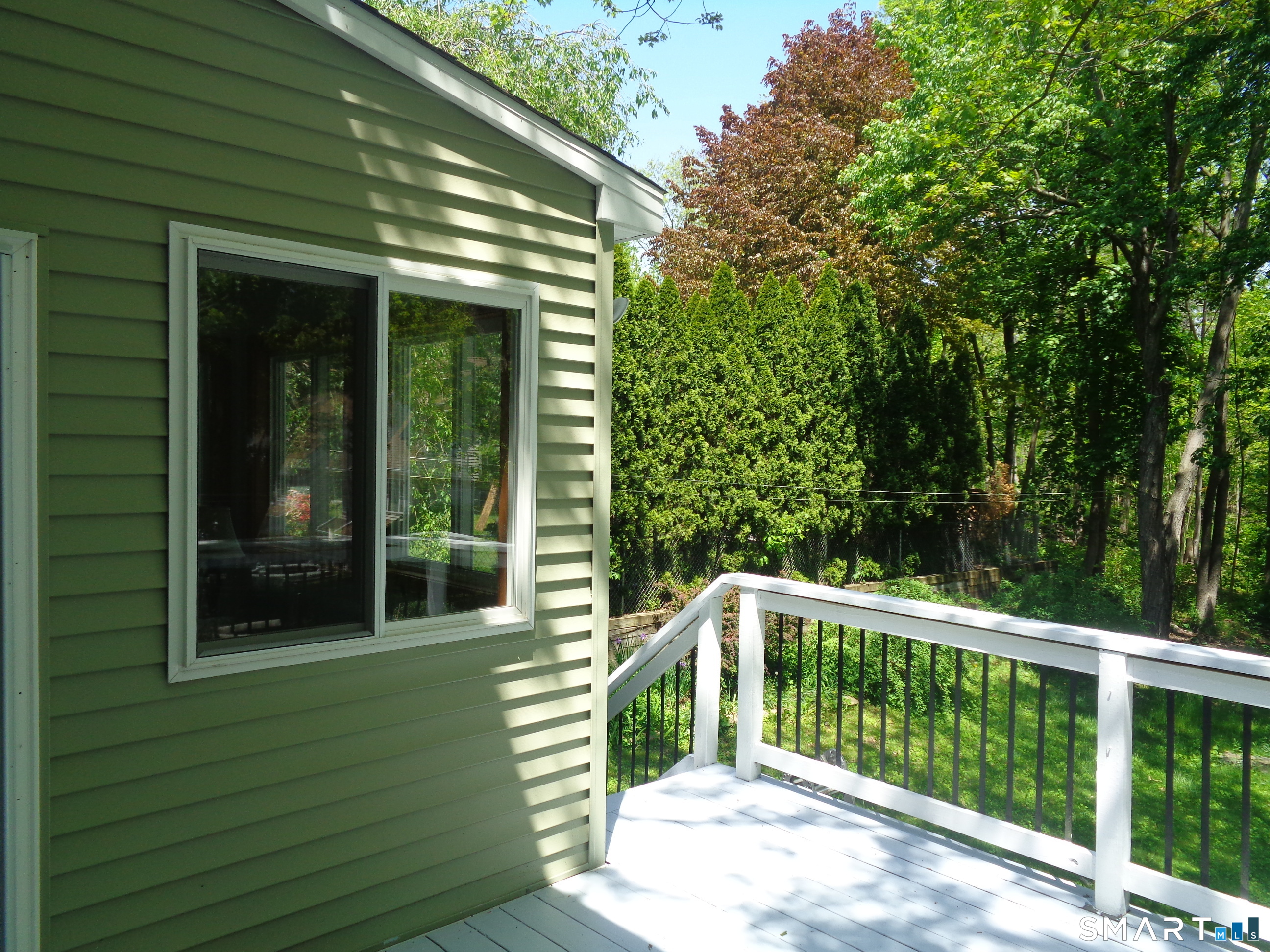 321 Spring Street Naugatuck, CT 06770 - Photo 26 of 27 a balcony with trees in front of it