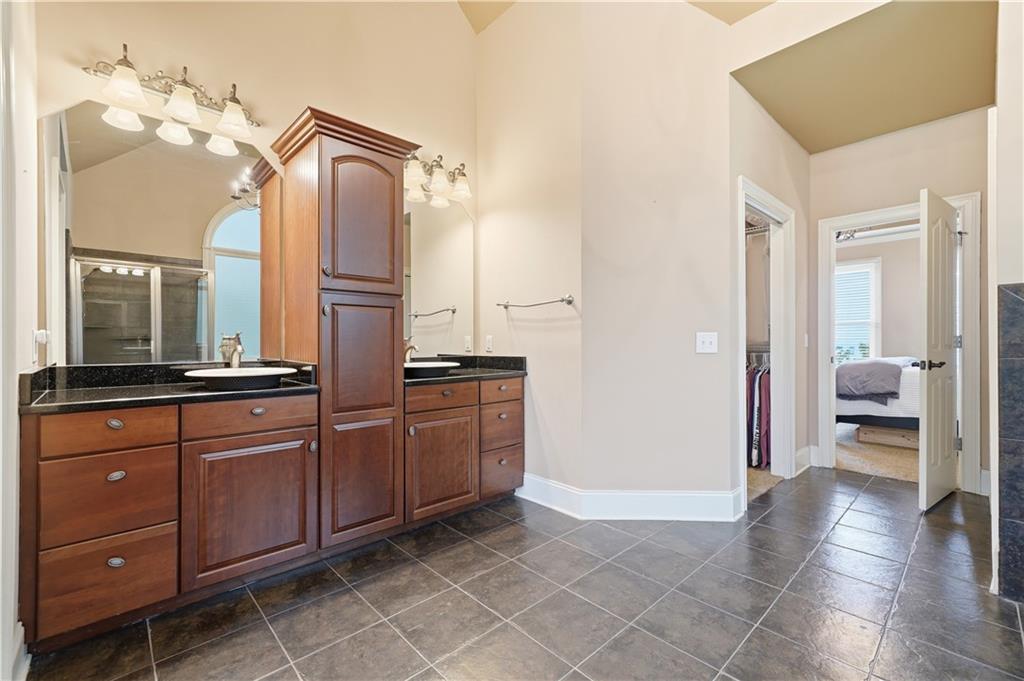 97 Eagle Ridge Trail Cleveland, GA 30528 - Photo 36 of 58 a spacious bathroom with a granite countertop sink a mirror and a vanity