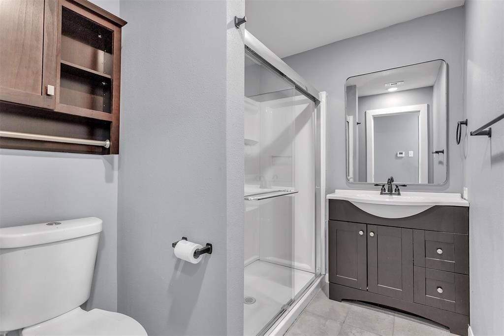 904 North Virginia Street Terrell, TX 75160 - Photo 17 of 22 a bathroom with a granite countertop sink toilet and shower