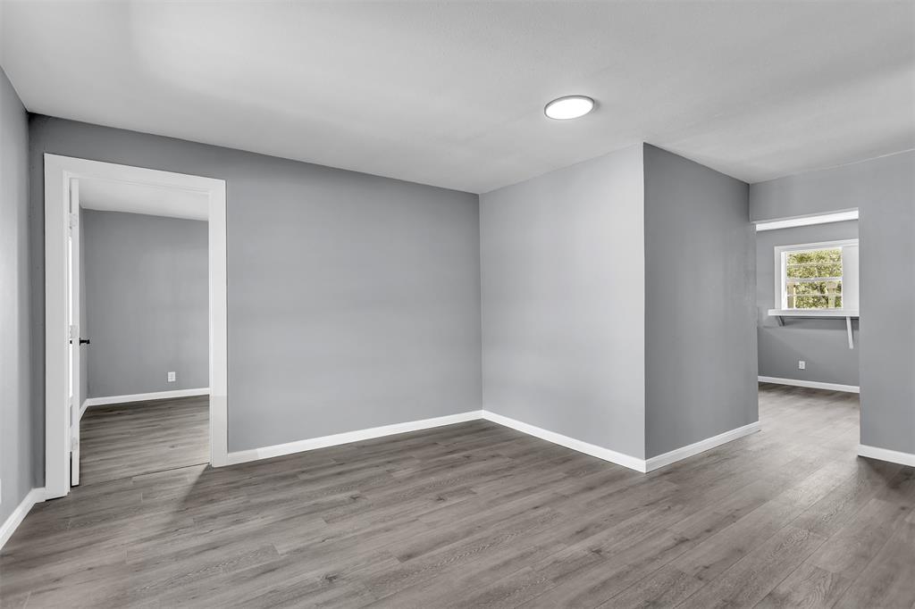 904 North Virginia Street Terrell, TX 75160 - Photo 7 of 22 a view of an empty room with wooden floor and a window
