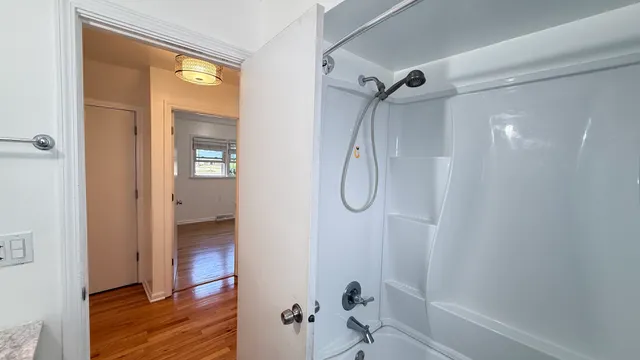 a bathroom with a shower and a glass door