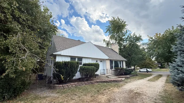 a view of a house with backyard and sitting area