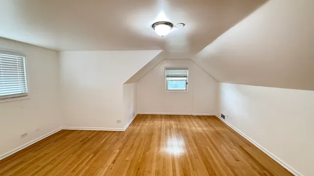 a view of a room with wooden floor and window