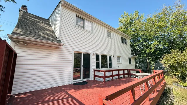 a view of a house with wooden deck