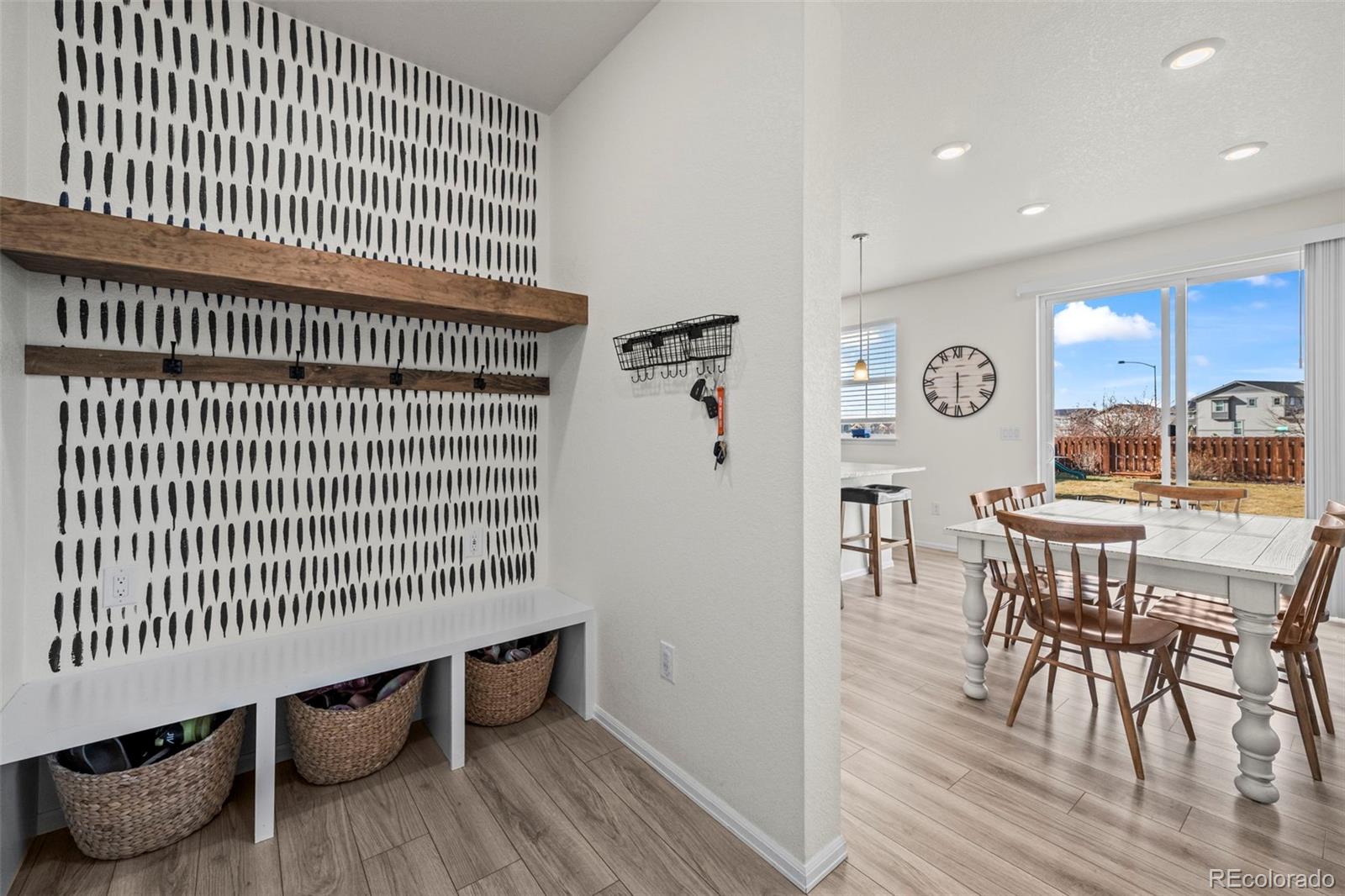 10985 Wheeling Street Commerce City, CO 80022 - Photo 11 of 45 a view of a dining room with furniture and wooden floor