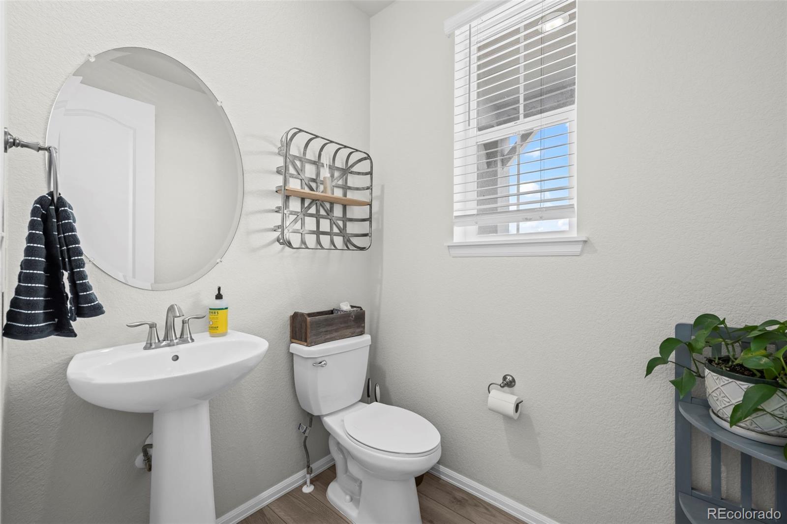 10985 Wheeling Street Commerce City, CO 80022 - Photo 12 of 45 a bathroom with a sink toilet and a mirror
