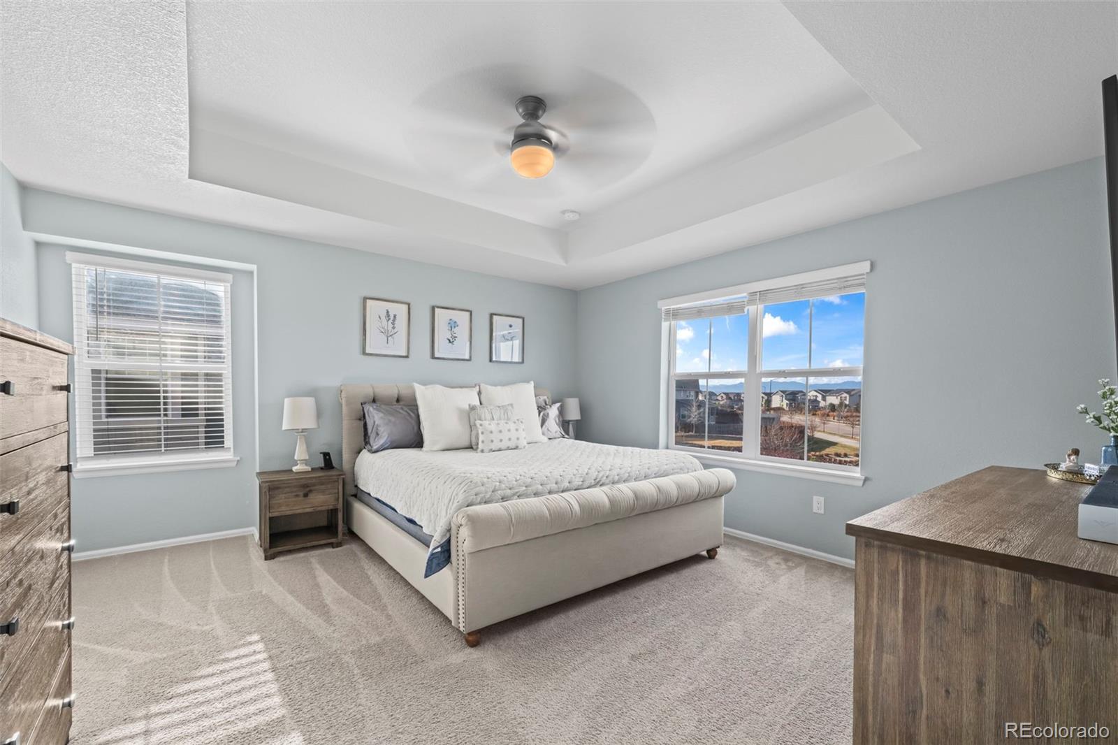 10985 Wheeling Street Commerce City, CO 80022 - Photo 13 of 45 a spacious bedroom with a large bed and a window
