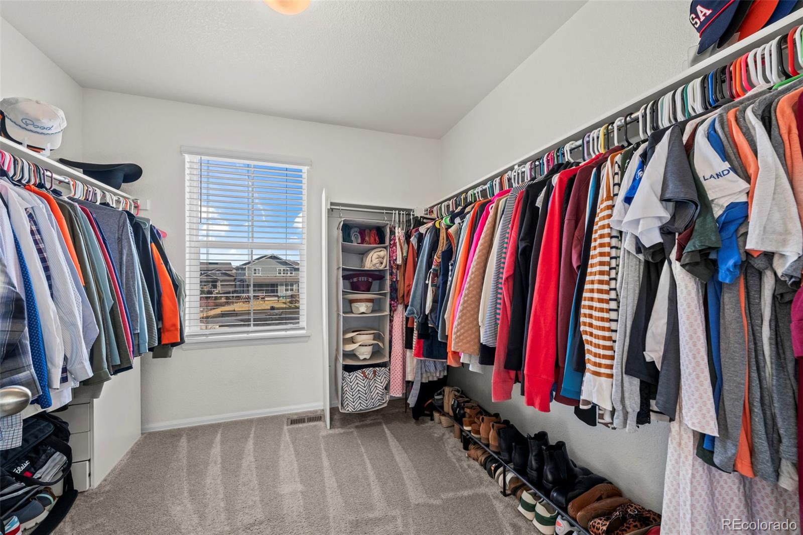 10985 Wheeling Street Commerce City, CO 80022 - Photo 16 of 45 a view of walk in closet with clothes and shoes