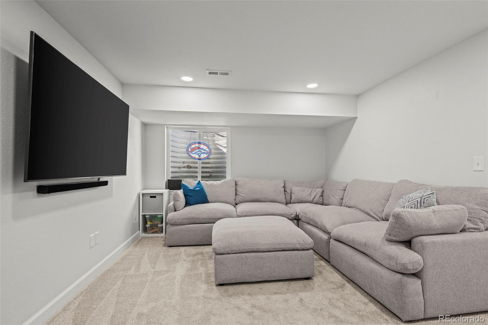10985 Wheeling Street Commerce City, CO 80022 - Photo 20 of 45 a living room with furniture and a flat screen tv