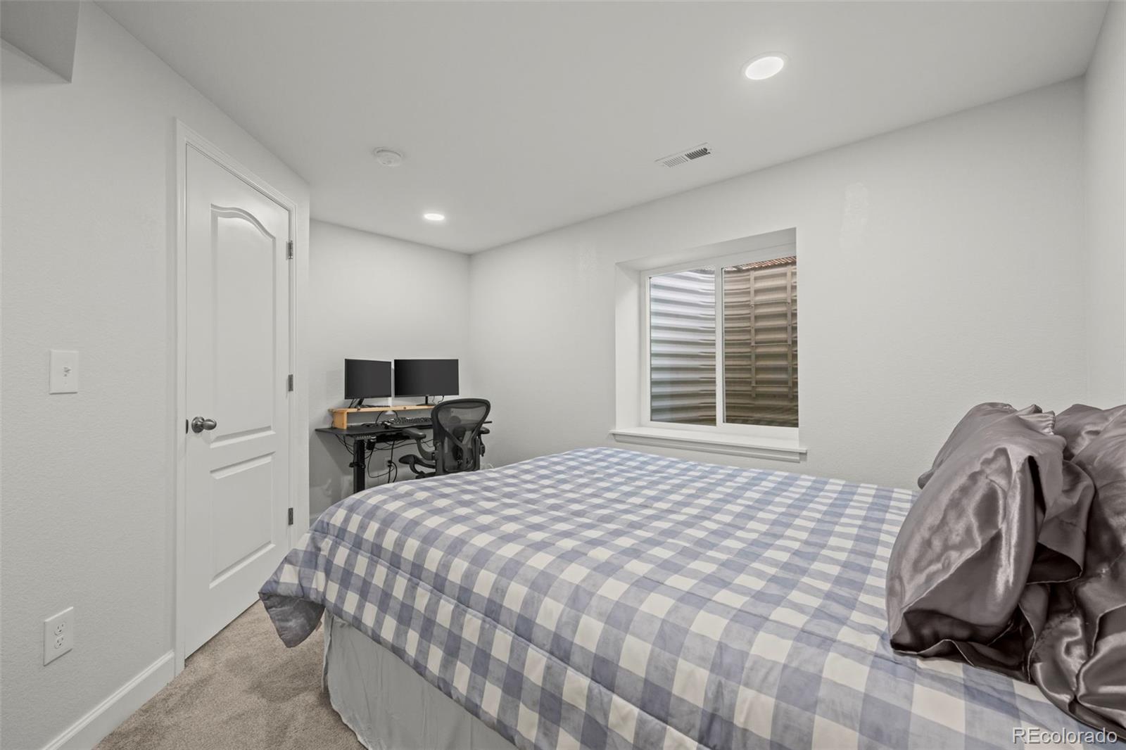 10985 Wheeling Street Commerce City, CO 80022 - Photo 22 of 45 a bedroom with a bed and a chair