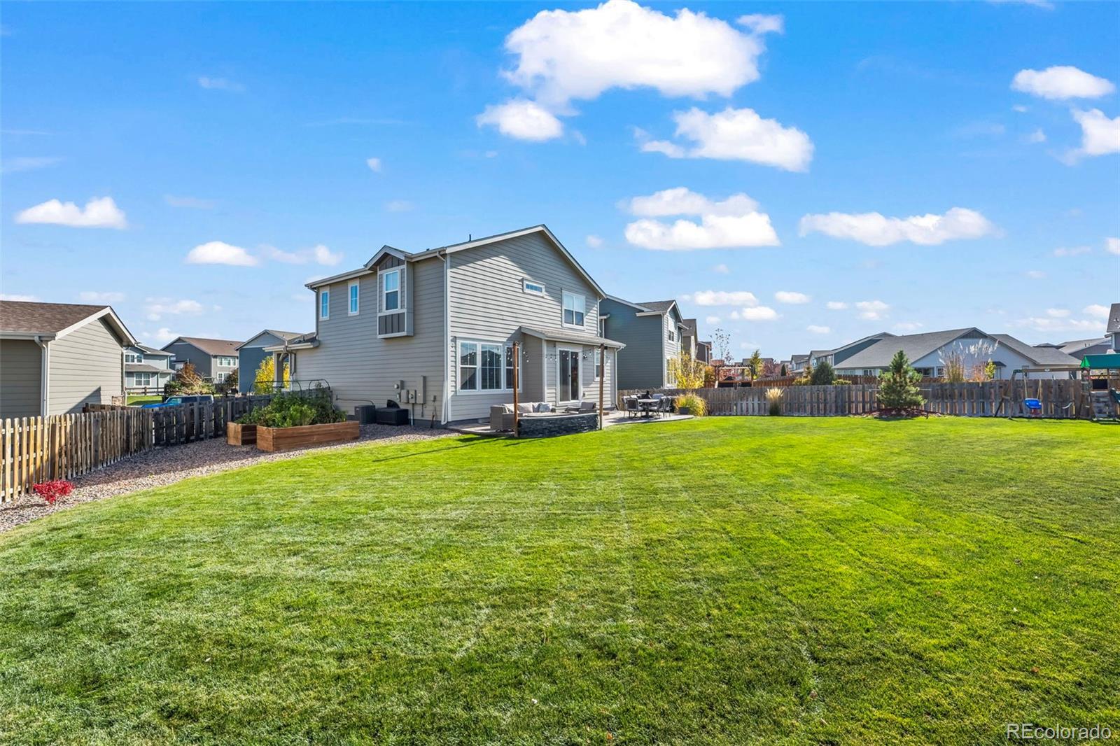 10985 Wheeling Street Commerce City, CO 80022 - Photo 28 of 45 a front view of a house with garden