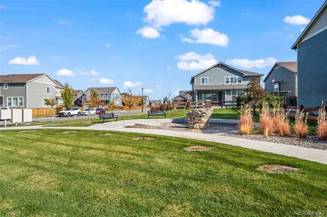 a view of a house with a small yard and potted plants