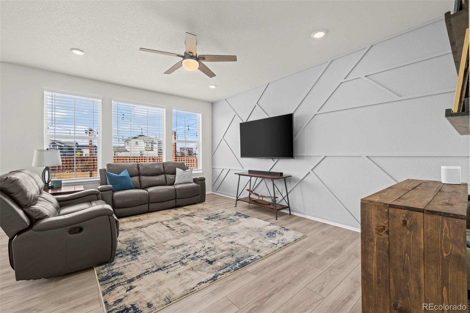 10985 Wheeling Street Commerce City, CO 80022 - Photo 5 of 45 a living room with furniture and a flat screen tv