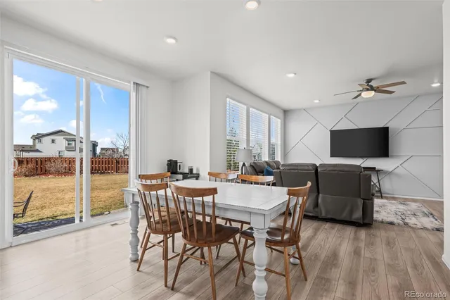 a view of a dining room with furniture window and wooden floor