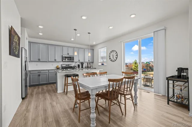 a view of kitchen with cabinets table and chairs