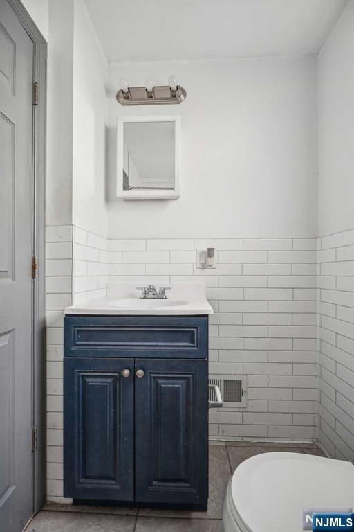 143 Valley Road, Unit 1R Montclair, NJ 07042 - Photo 12 of 18 a bathroom with a toilet a sink and mirror