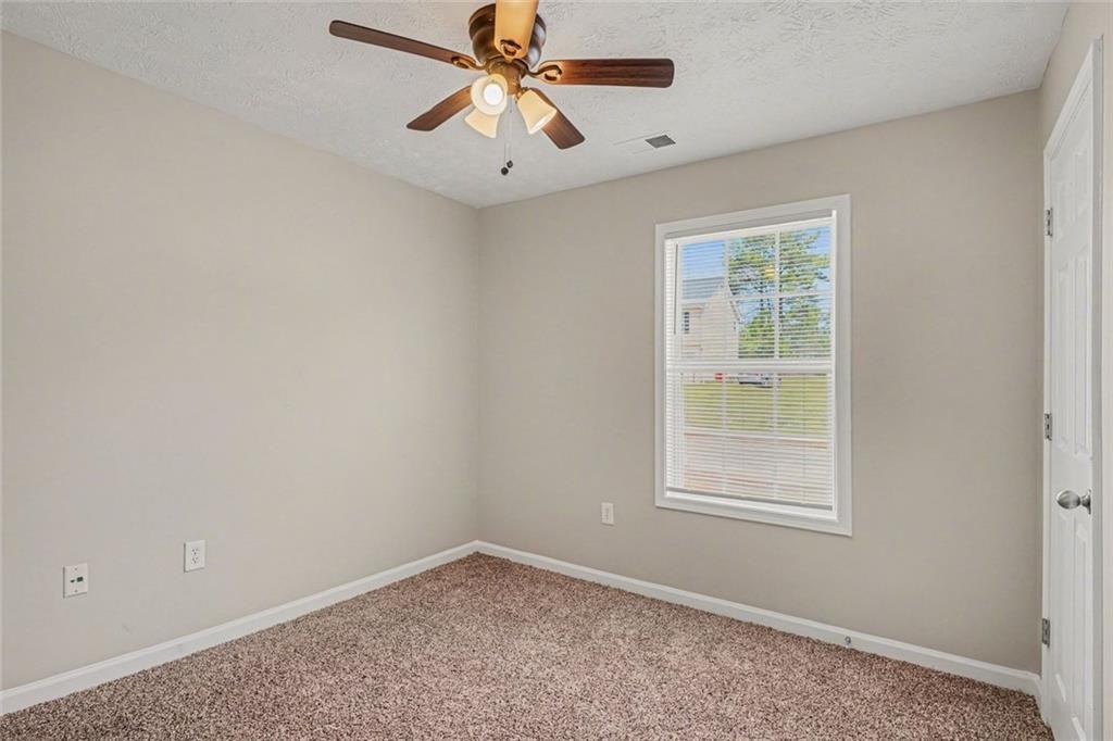10 Wilbur Way Covington, GA 30016 - Photo 14 of 22 an empty room with windows and fan