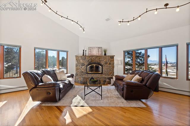 8210 Hodgen Road Colorado Springs, CO 80908 - Photo 10 of 27 Great Room has a gas fireplace with stone surround.