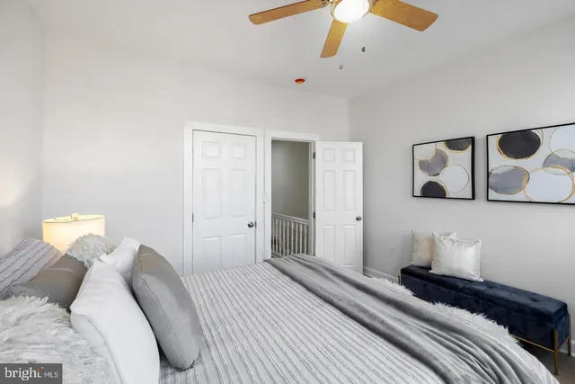 a bedroom with a bed and a painting on the wall