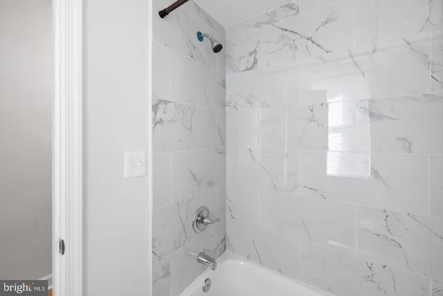 a bathroom with a bathtub and shower