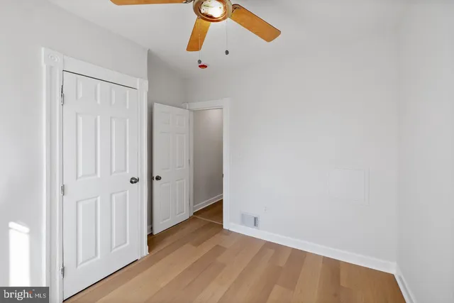 a view of a room with wooden floor
