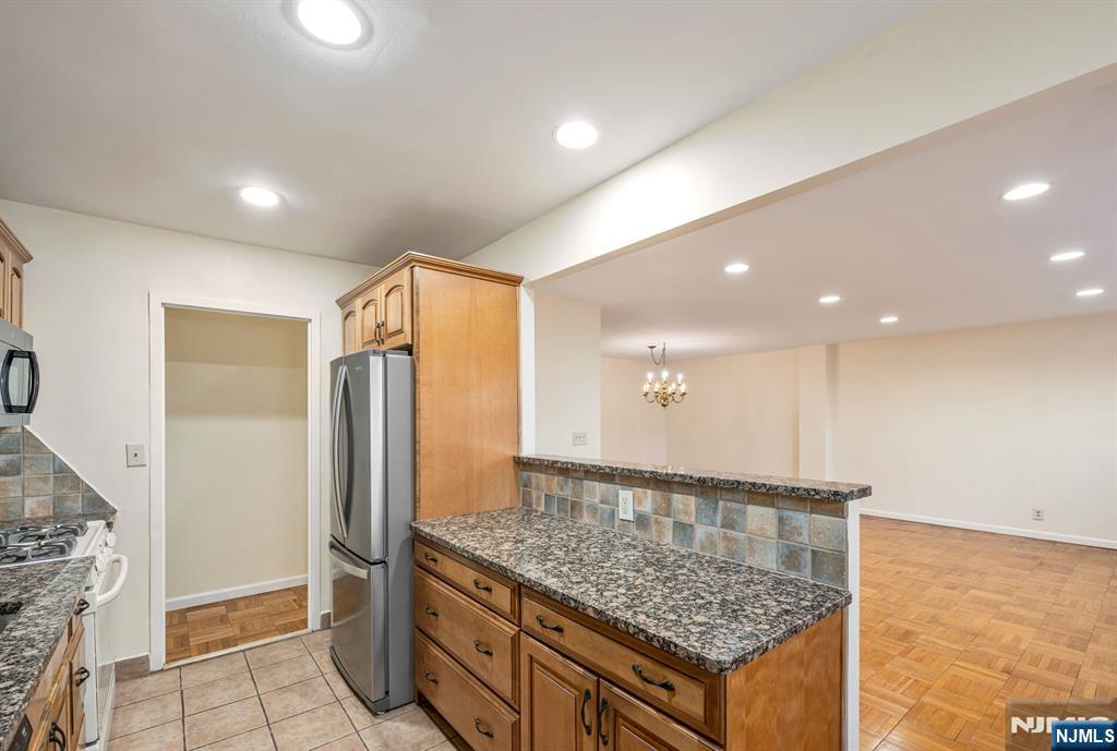 280 Prospect Avenue, Unit 1B Hackensack, NJ 07601 - Photo 14 of 36 a kitchen with stainless steel appliances granite countertop a refrigerator and a sink