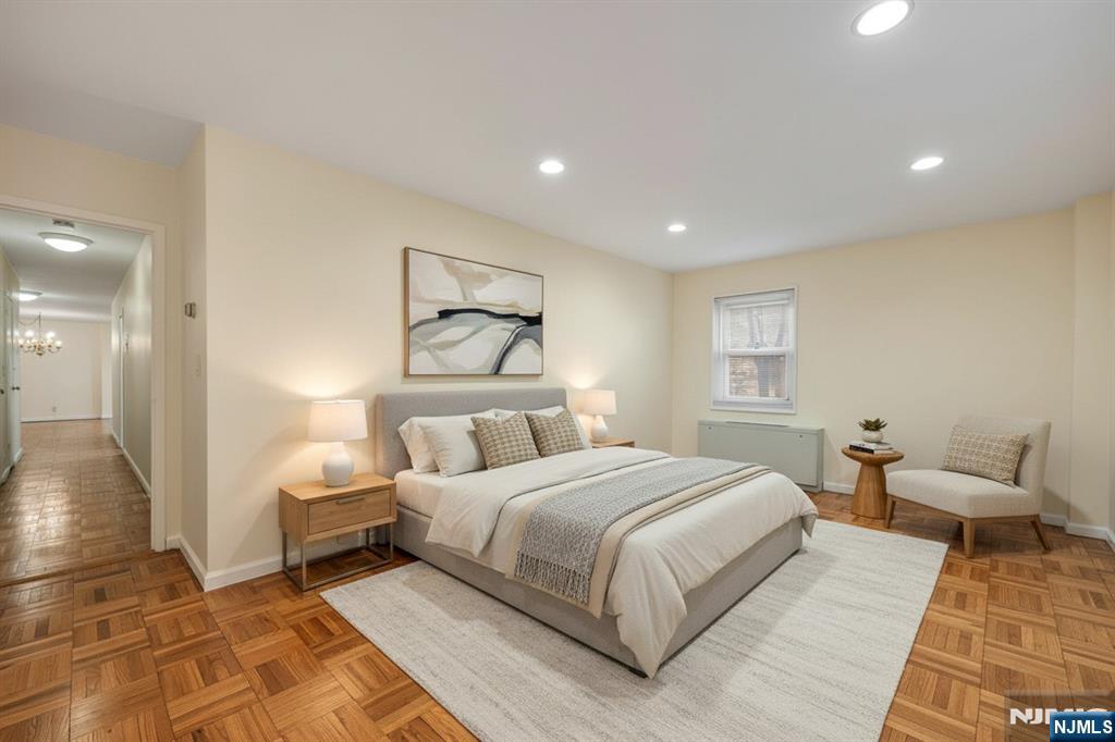 280 Prospect Avenue, Unit 1B Hackensack, NJ 07601 - Photo 16 of 36 a bedroom with a large bed and a couch