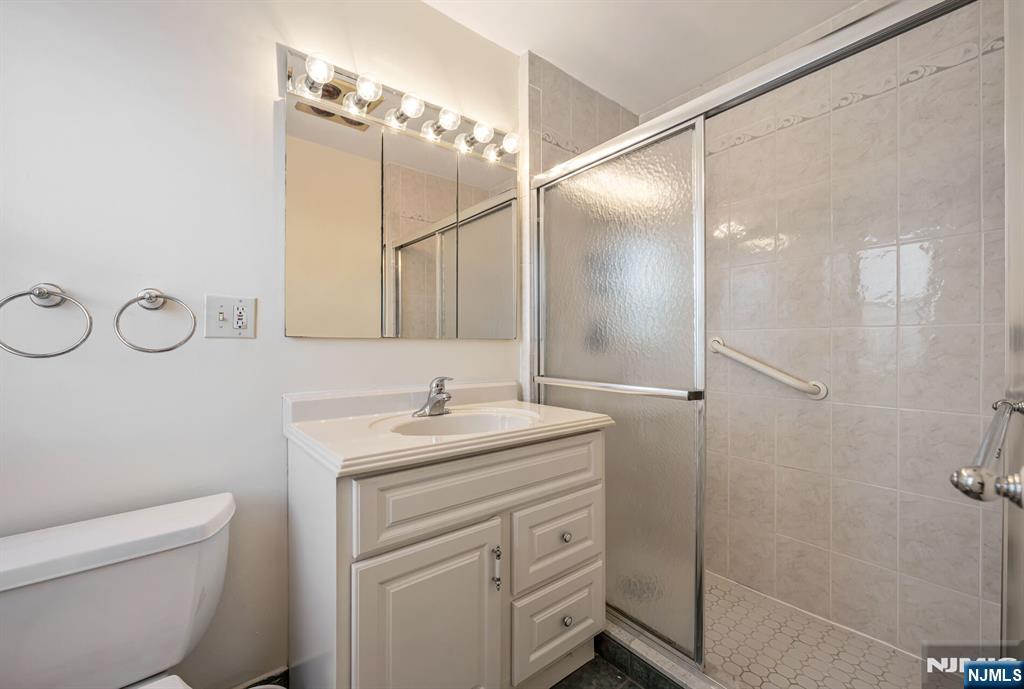280 Prospect Avenue, Unit 1B Hackensack, NJ 07601 - Photo 19 of 36 a bathroom with a sink a toilet and shower
