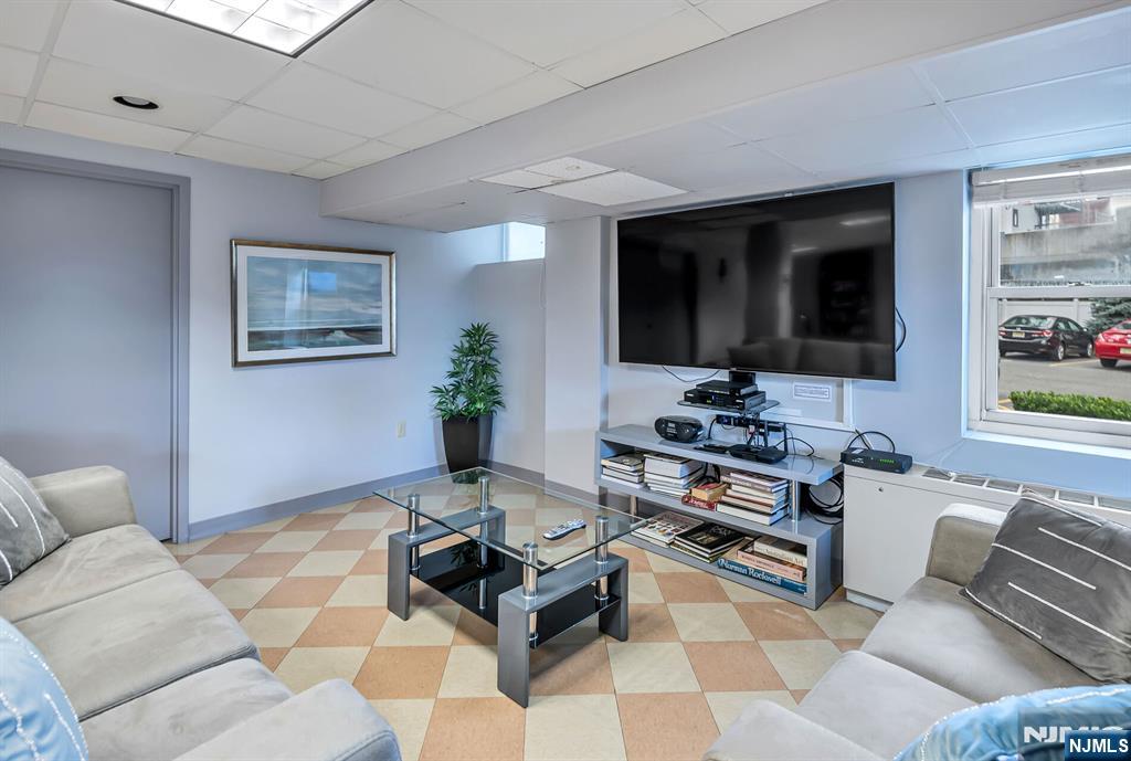 280 Prospect Avenue, Unit 1B Hackensack, NJ 07601 - Photo 28 of 36 a living room with furniture and a flat screen tv
