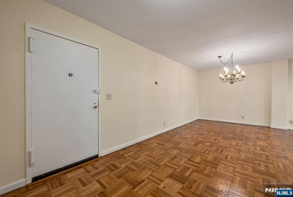 280 Prospect Avenue, Unit 1B Hackensack, NJ 07601 - Photo 4 of 36 a view of an empty room with a chandelier fan