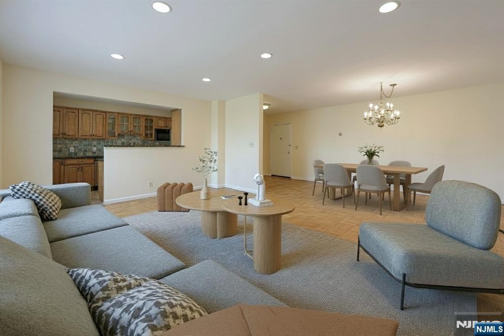 280 Prospect Avenue, Unit 1B Hackensack, NJ 07601 - Photo 6 of 36 a living room with furniture and a chandelier