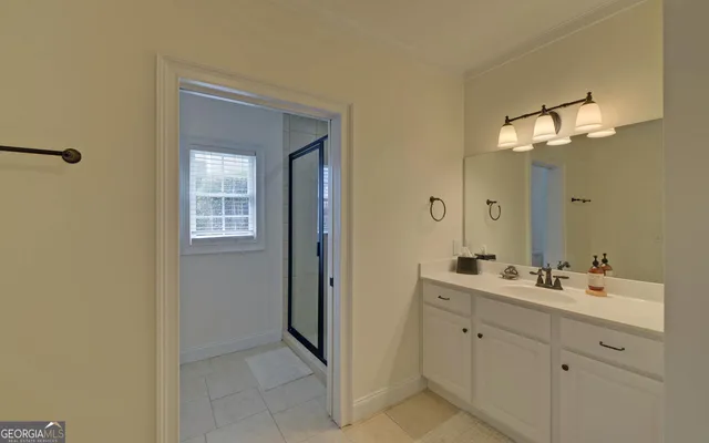 a bathroom with a shower and a glass door