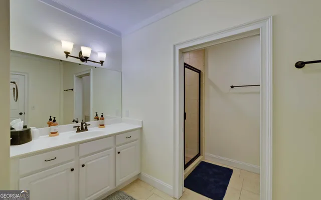 a bathroom with a shower and a sink