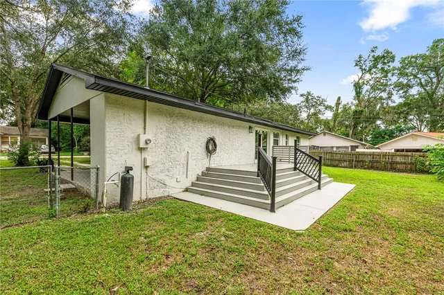 a front view of house with yard and trees