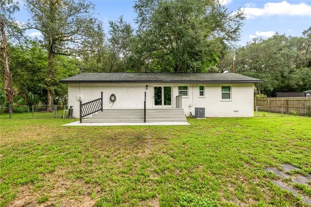 a white house that has a tree in front of it